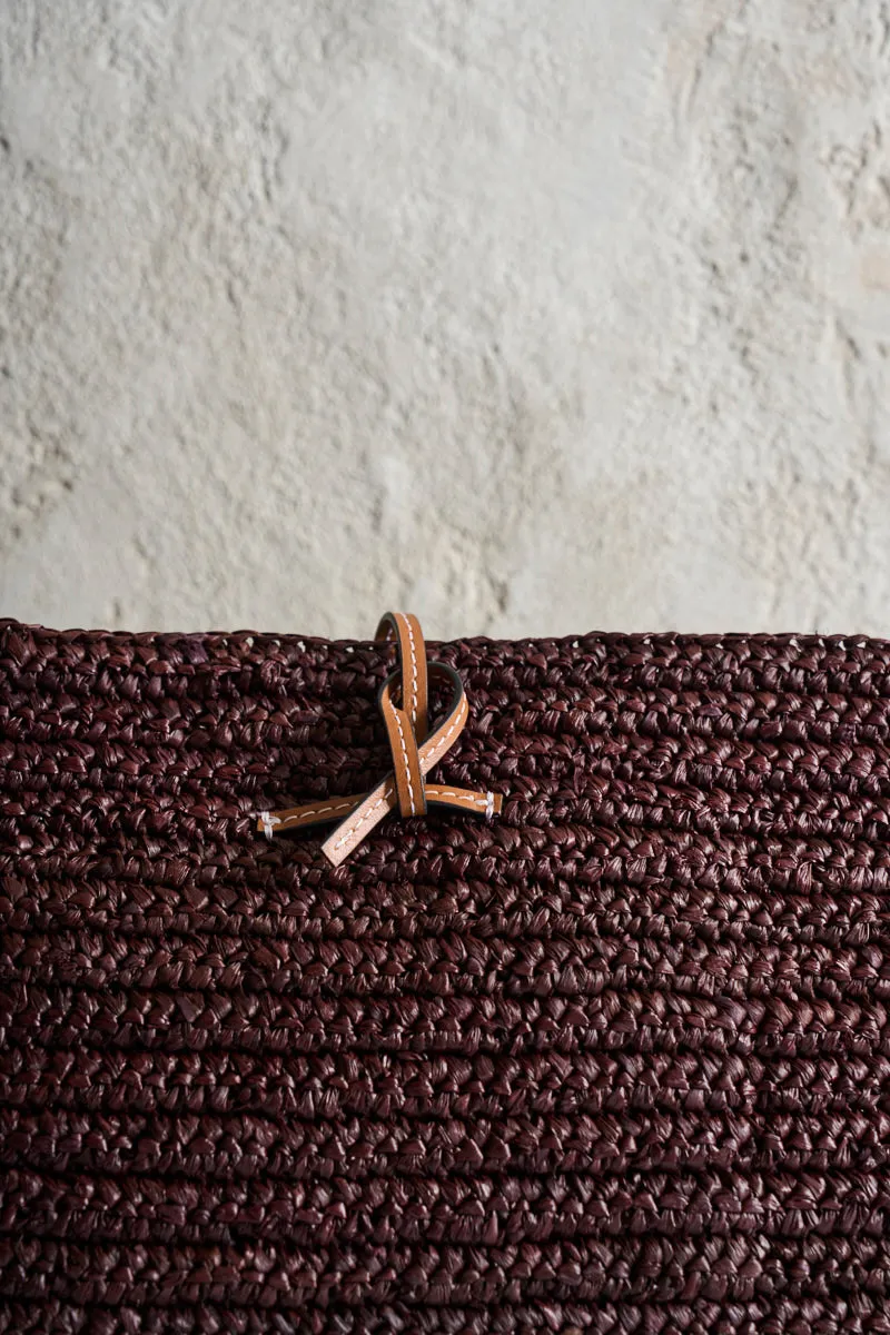 Brown raffia clutch bag.