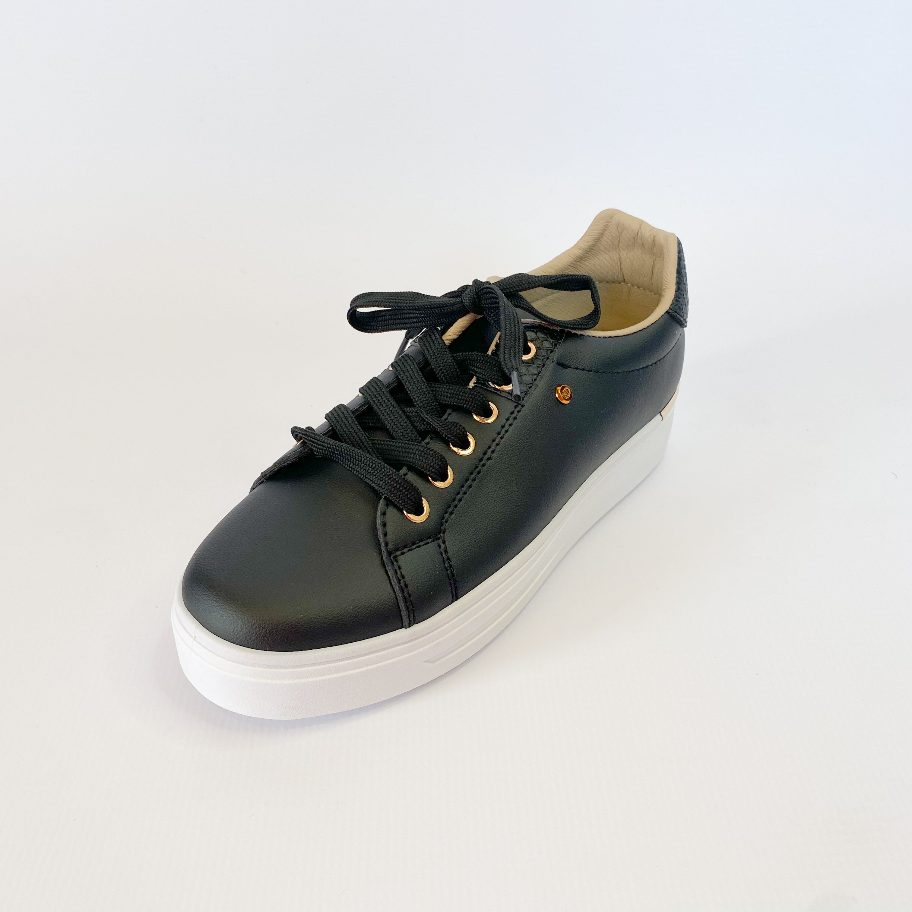 KG black sneaker with gold eyelet.