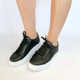 KG black sneaker with gold eyelet.