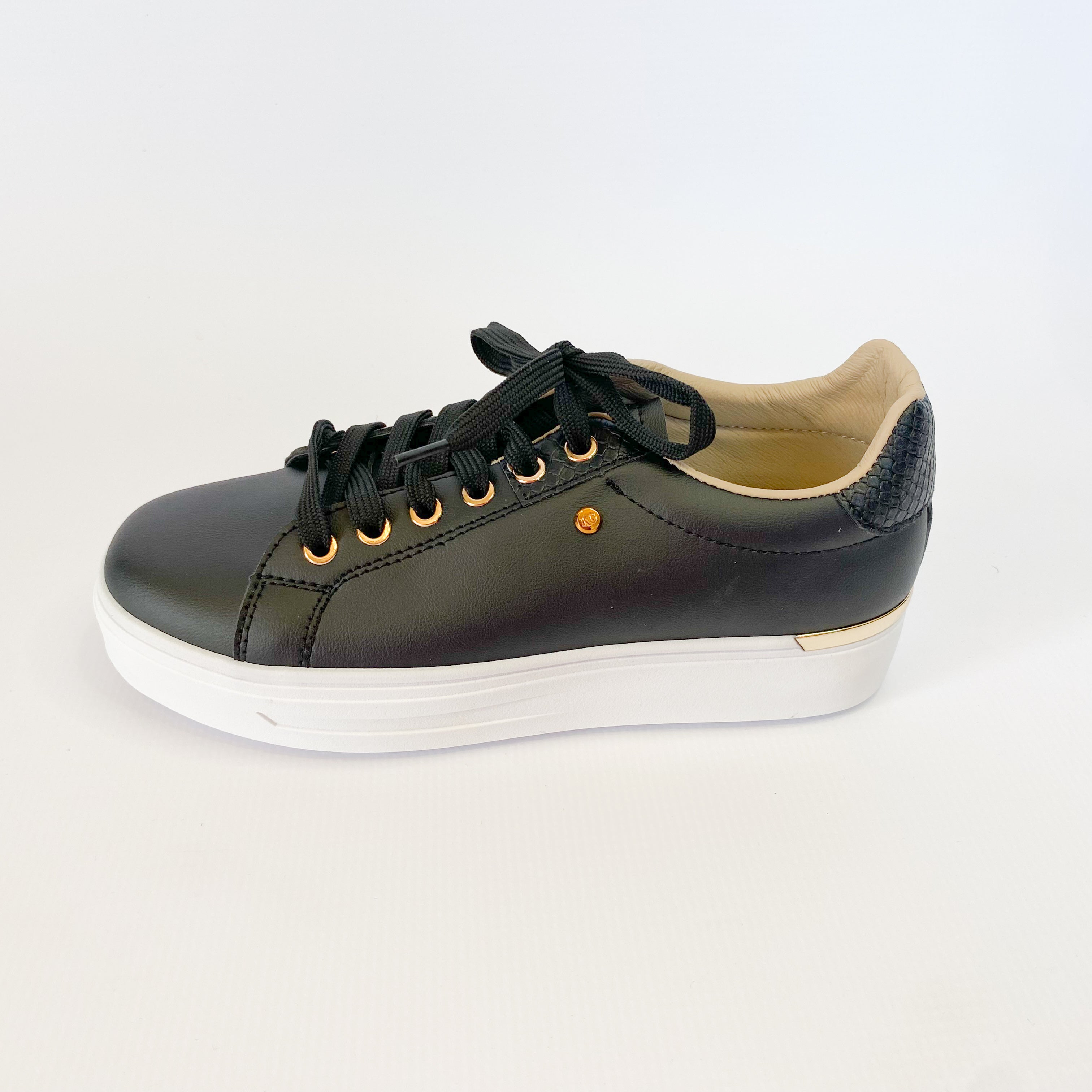 KG black sneaker with gold eyelet.