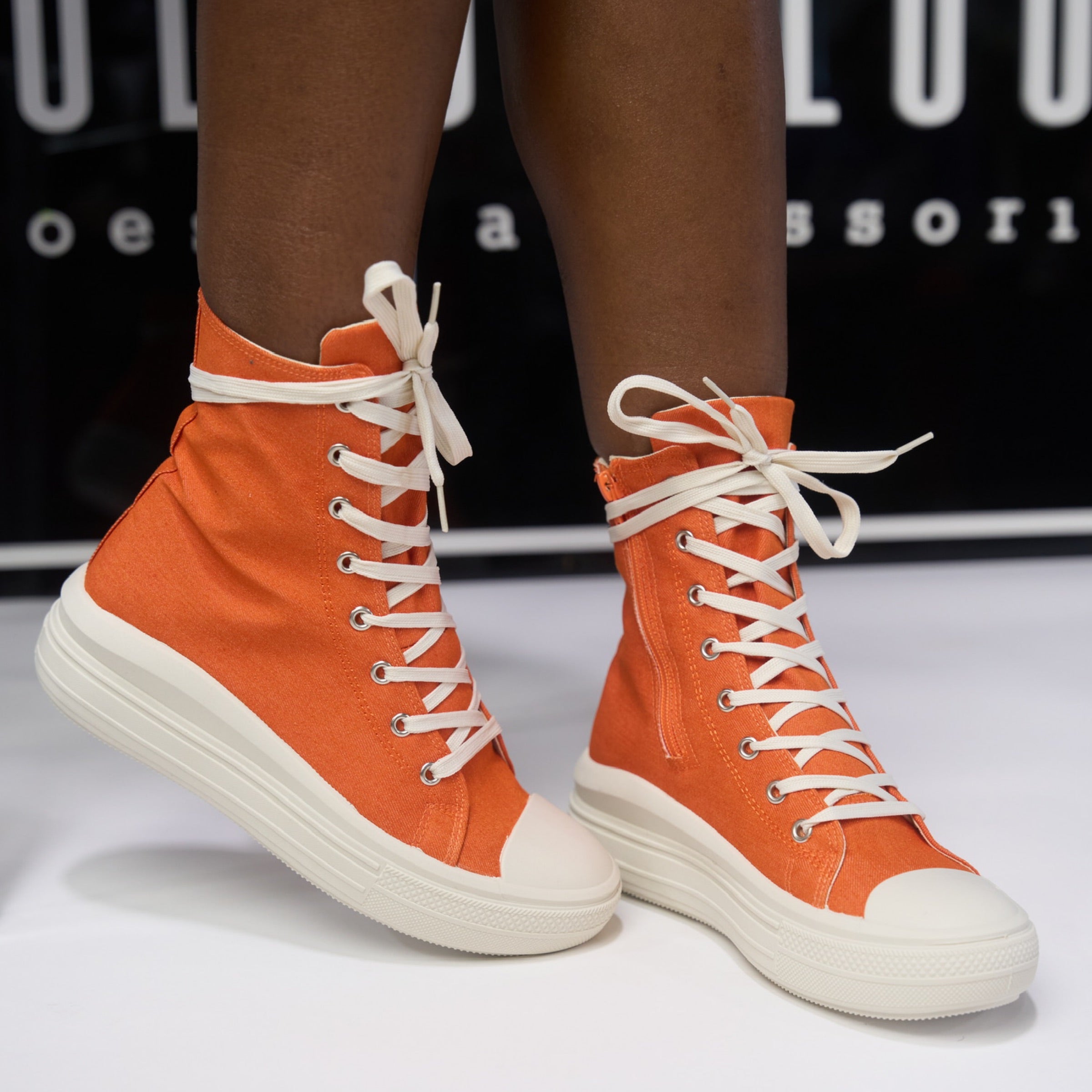 orange lace sneakers with extendo feature and swoosh